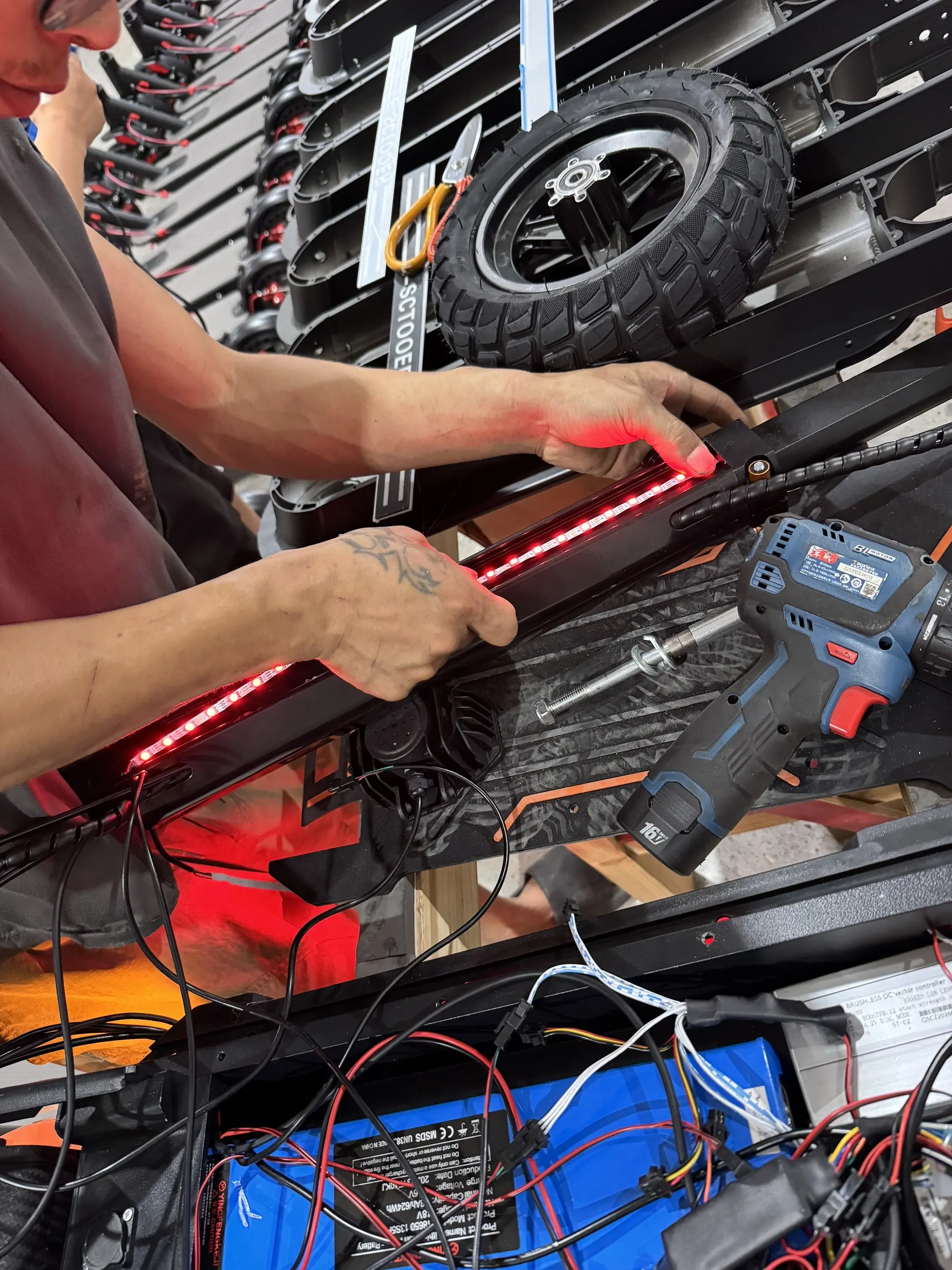 Hands-on electric scooter assembly and LED lighting work in our workshop