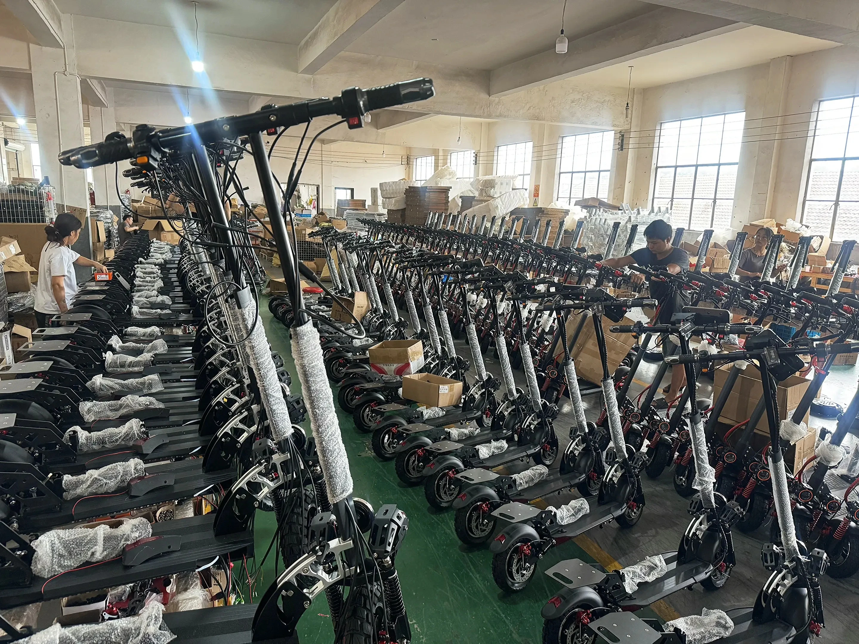 Electric scooters being assembled at our factory