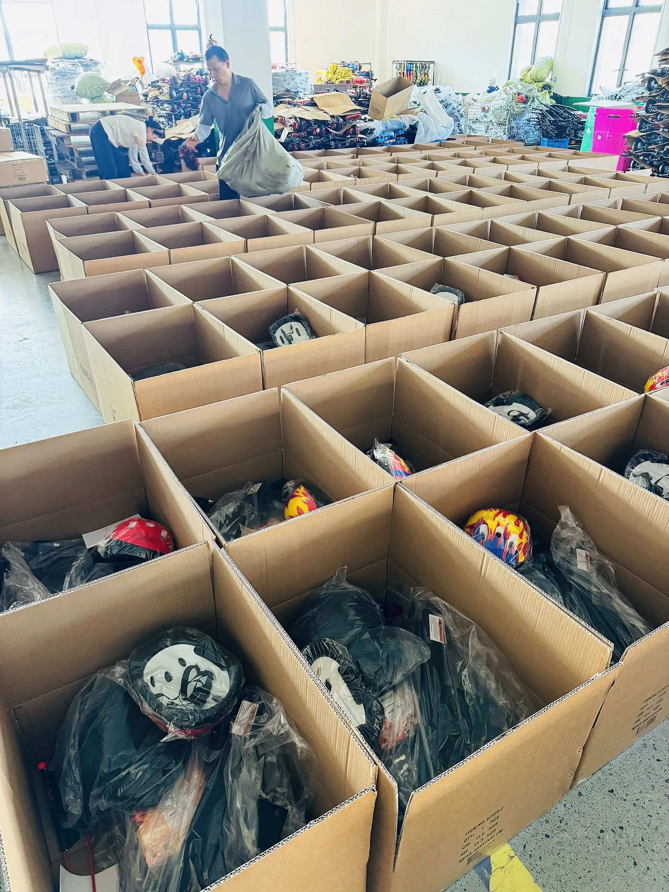 Our workshop team packing electric scooters into individual cartons